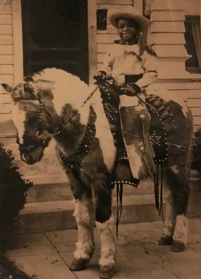 A young Ken Warfield playing cowboy.