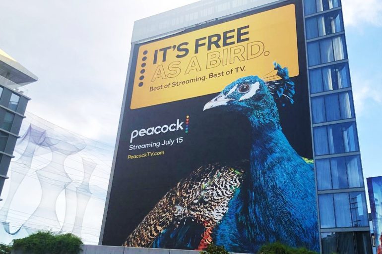 A poster of the Peacock streaming service on a large building