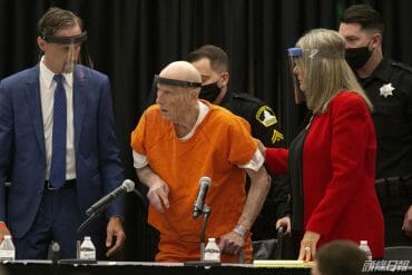 Joseph James DeAngelo, center, charged with being the Golden State Killer, is helped up by his attorney, Diane Howard.