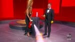 Jennifer Aniston puts out a small fire as Jimmy Kimmel gets ready to open a now-sanitized award envelope during the Emmys.