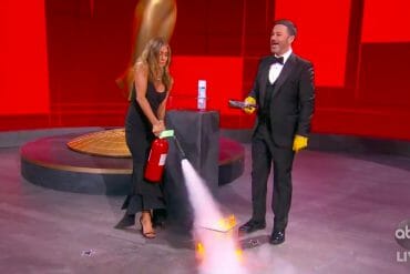 Jennifer Aniston puts out a small fire as Jimmy Kimmel gets ready to open a now-sanitized award envelope during the Emmys.