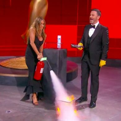 Jennifer Aniston puts out a small fire as Jimmy Kimmel gets ready to open a now-sanitized award envelope during the Emmys.