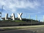 Three large letter fixtures spelling "LAX" mark the entrance of the Los Angeles International Airport.