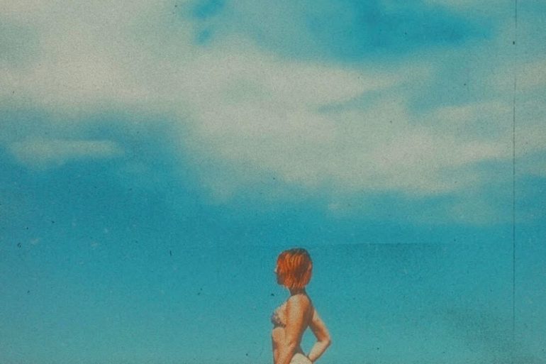 Lauren Willow White aka Lauren Rocketagainst a blue cloudy sky