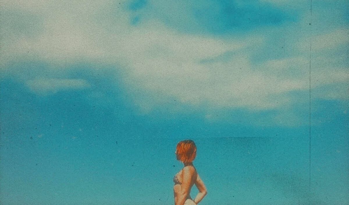 Lauren Willow White aka Lauren Rocketagainst a blue cloudy sky