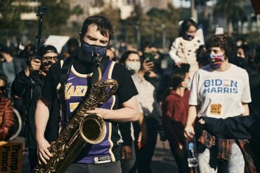 A saxophone-wielding marcher celebrates Joe Biden's victory over President Donald Trump Saturday, Nov. 7, 2020.