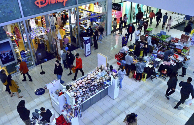 Masked shoppers make their way through Glendale Galleria on Wednesday, Dec. 23, 2020.